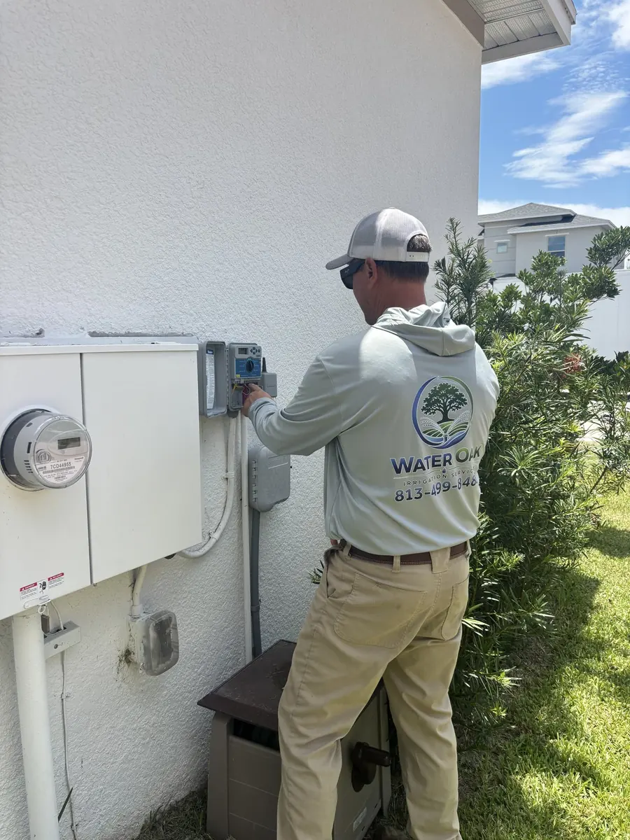 Water Oak Irrigation technician servicing an irrigation system controller during a design consultation in Tampa, FL