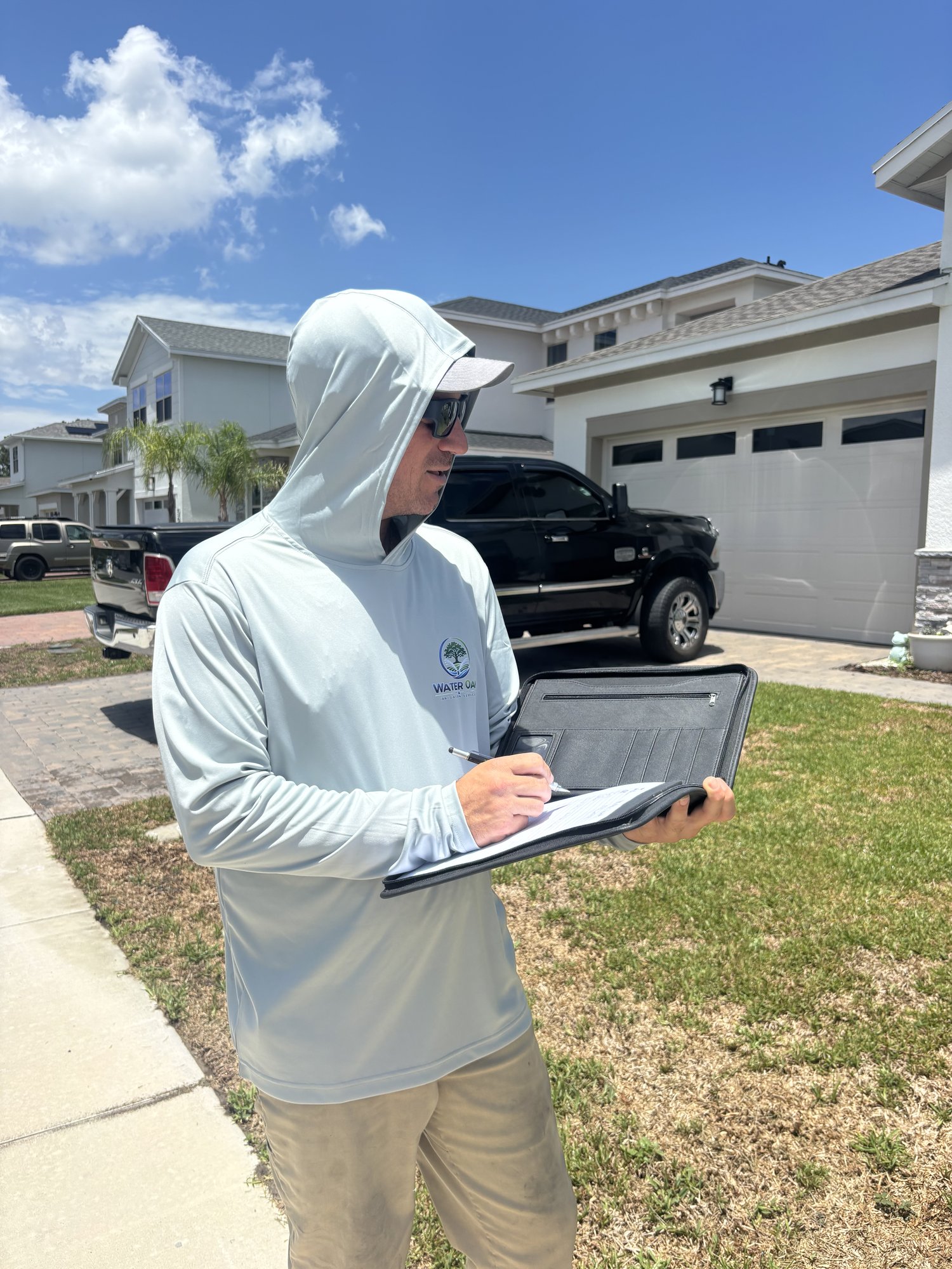 Irrigation technician documenting a sprinkler repair estimate for a Tampa, FL homeowner