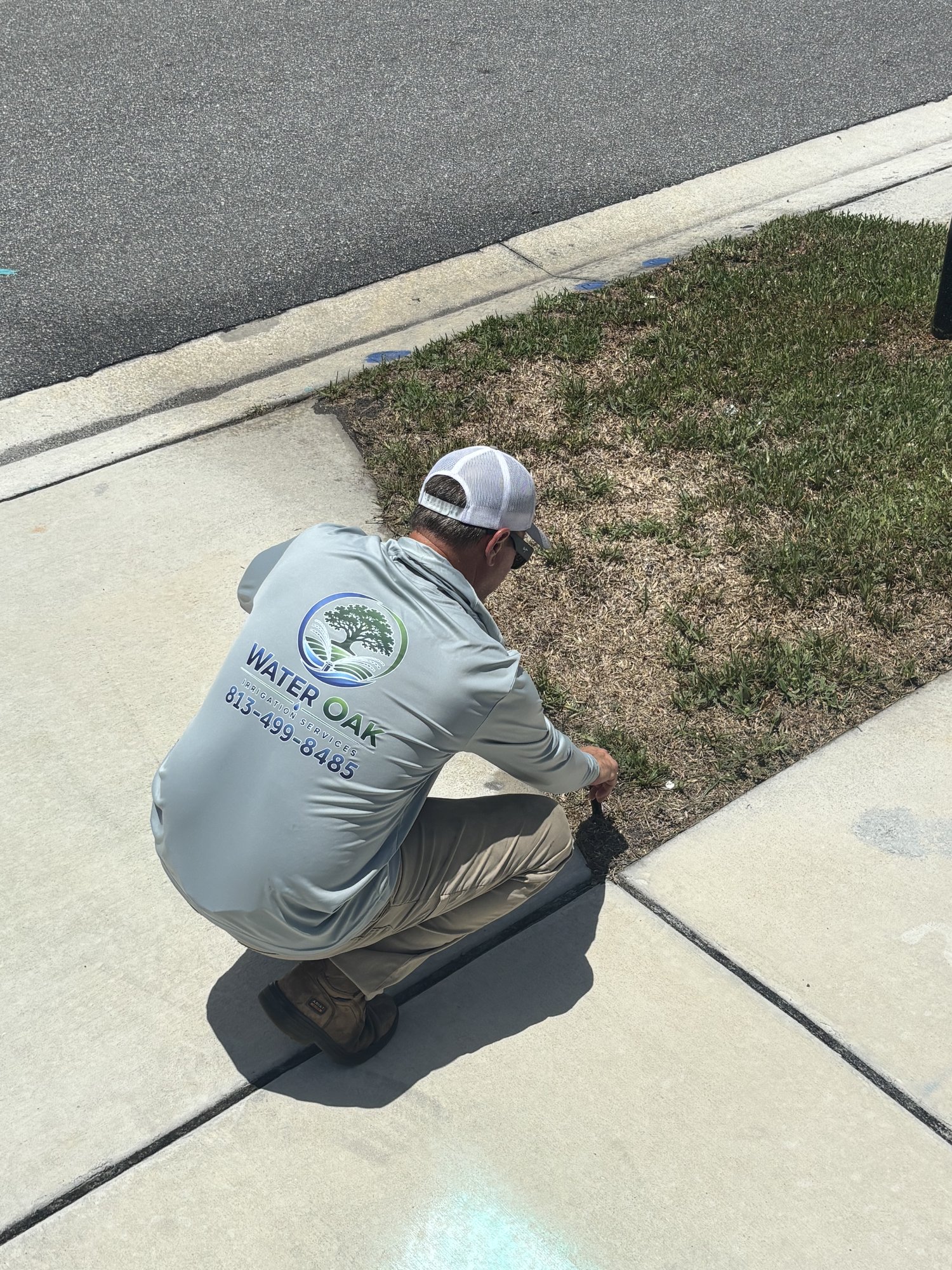Water Oak Irrigation technician repairing a broken sprinkler line in Tampa, FL