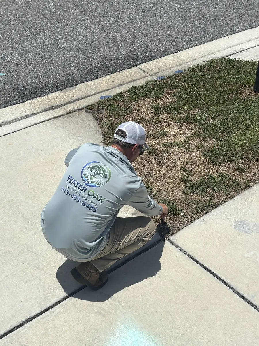 Water Oak Irrigation technician repairing a broken sprinkler line in Tampa, FL