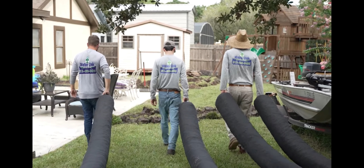 The Water Oak Irrigation team carrying EZflow drainage materials on a job site in Tampa Bay